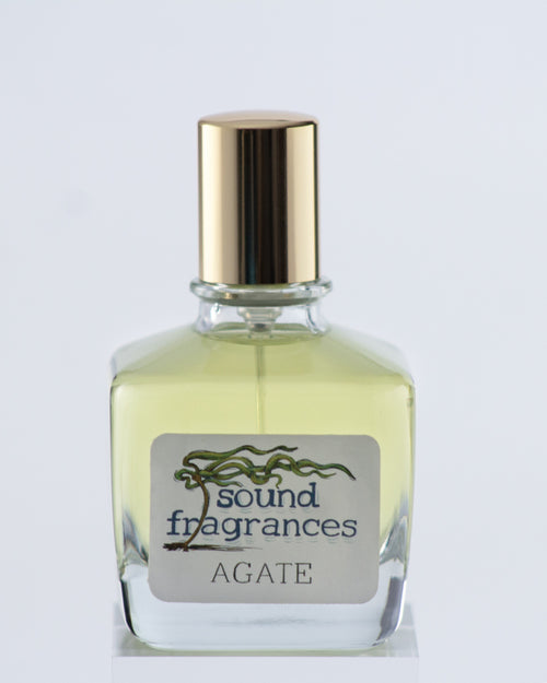 Agate perfume by Sound Fragrances, cold beach inspired Eau de Parfum bottle on gray background with gold lid — artisan fragrance from the Pacific Northwest.
