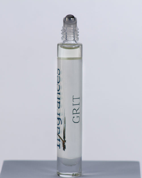 Grit perfume by Sound Fragrances, spicy Eau de Parfum travel roller bottle on gray background — artisan fragrance from the Pacific Northwest.