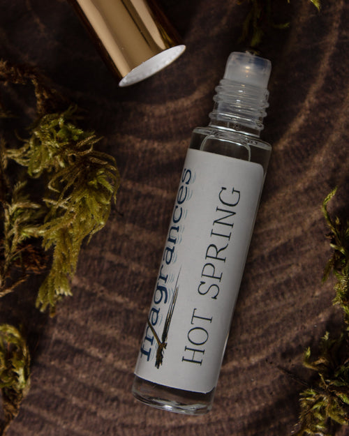 Hot Spring perfume by Sound Fragrances, thermal inspired Eau de Parfum mini bottle on wood surface with moss accents  — artisan fragrance from the Pacific Northwest.