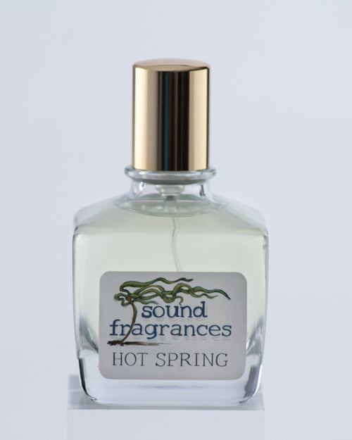 Hot Spring perfume by Sound Fragrances, thermal inspired Eau de Parfum bottle on gray background with gold lid — artisan fragrance from the Pacific Northwest.