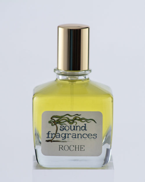 Roche perfume by Sound Fragrances, island-inspired Eau de Parfum bottle on gray background with gold lid — artisan fragrance from the Pacific Northwest.