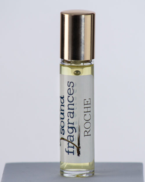 Roche perfume by Sound Fragrances, island-inspired Eau de Parfum travel bottle on gray background with gold lid — artisan fragrance from the Pacific Northwest.