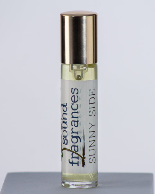 Sunny Side perfume by Sound Fragrances, forest inspired Eau de Parfum travel bottle on gray background with gold lid — artisan fragrance from the Pacific Northwest.