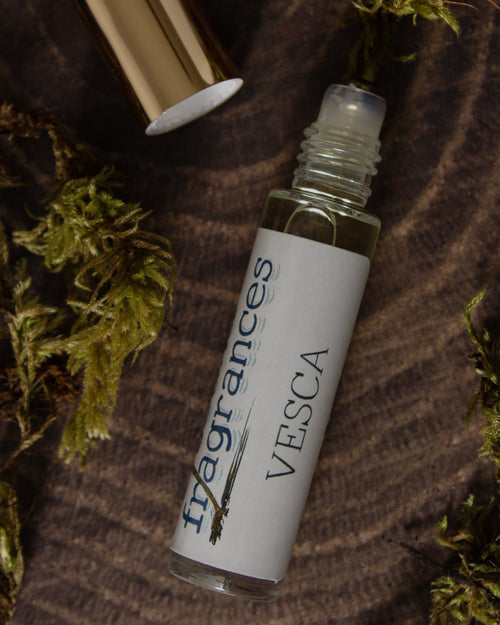 Vesca perfume by Sound Fragrances, berry inspired Eau de Parfum mini bottle on wood surface with moss accents  — artisan fragrance from the Pacific Northwest.