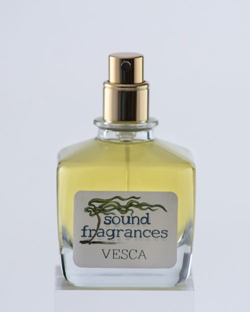 Vesca travel perfume by Sound Fragrances, berry-inspired Eau de Parfum bottle on gray background with gold lid — artisan fragrance from the Pacific Northwest.