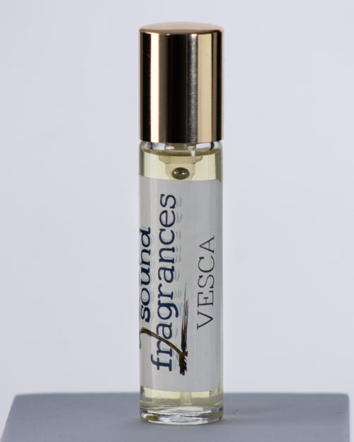 Vesca travel perfume by Sound Fragrances, berry-inspired Eau de Parfum bottle on gray background with gold lid — artisan fragrance from the Pacific Northwest.